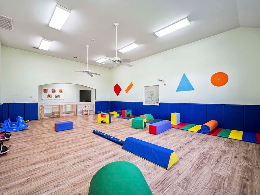 Playroom with soft play equipment and wall shapes