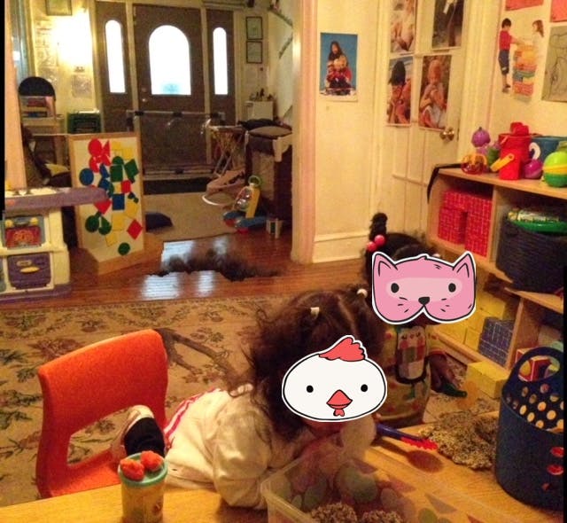 Child playing on the floor in a room with toys