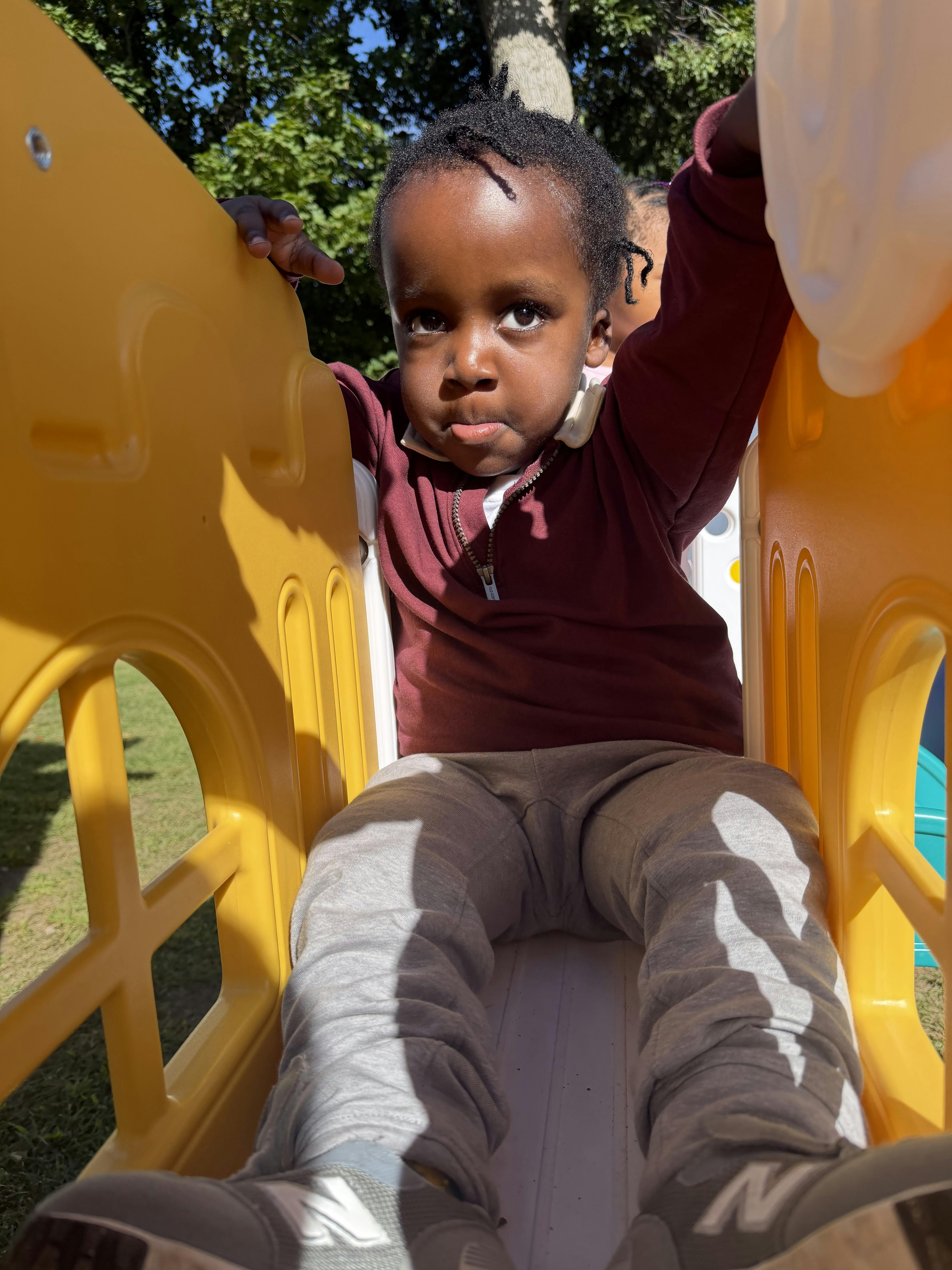 Child sitting on a playground slide