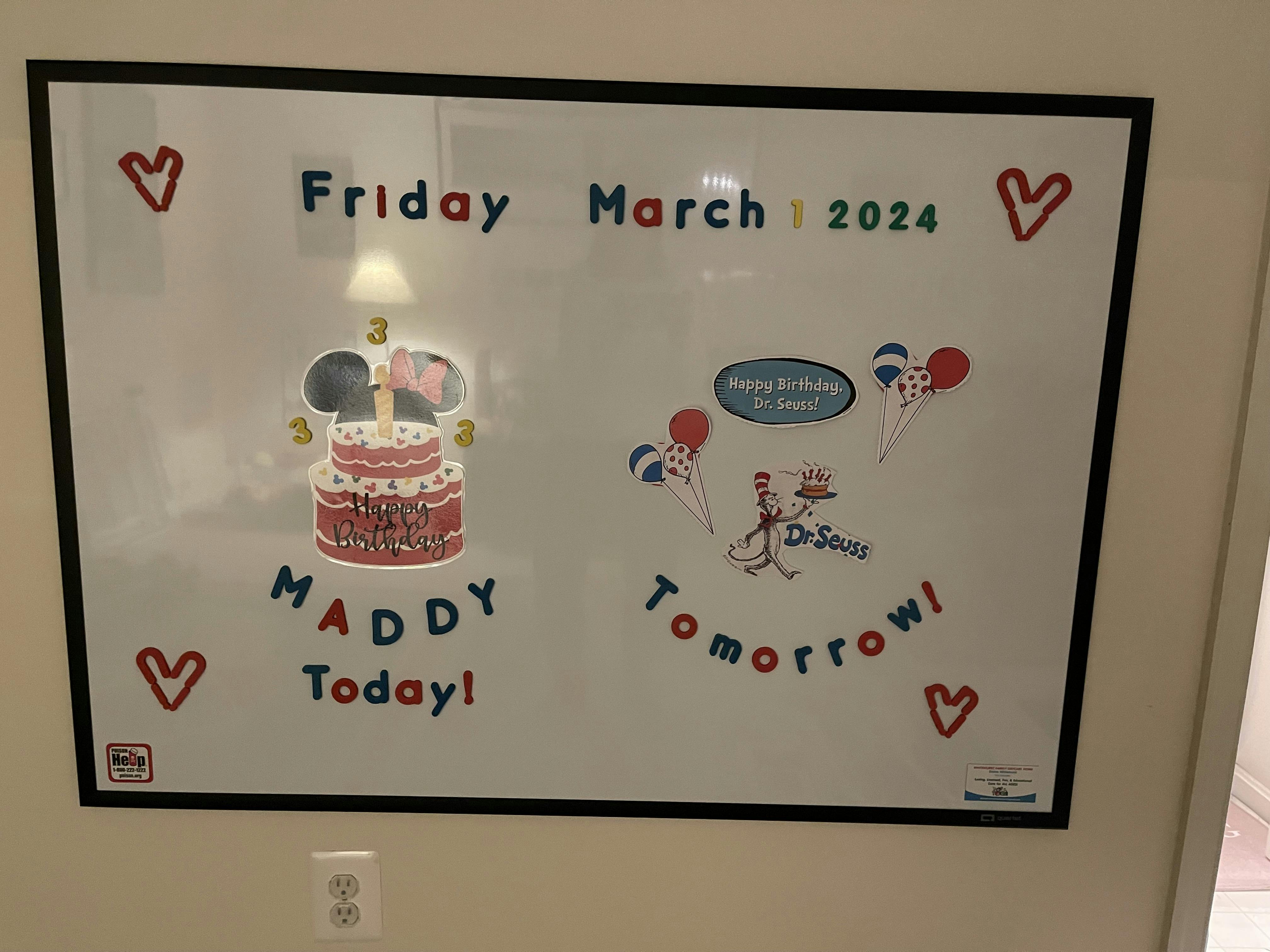 Whiteboard displaying the date and birthday messages with festive decorations
