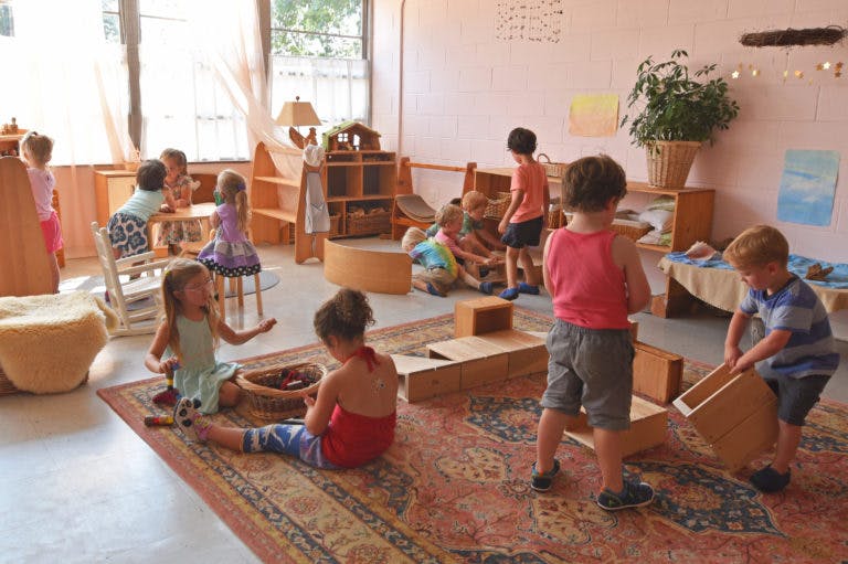 Children playing with toys in a classroom