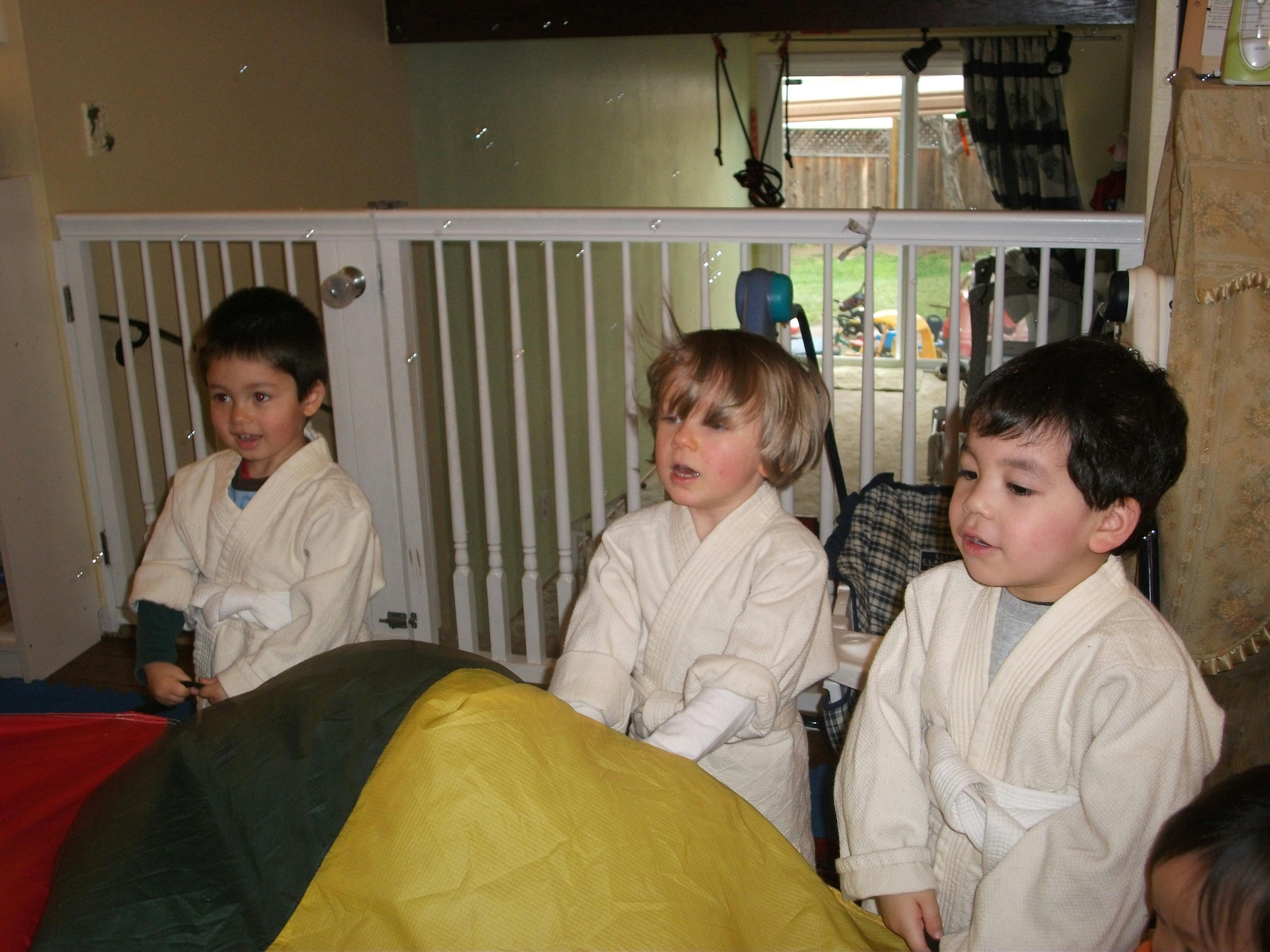 Three children in martial arts uniforms
