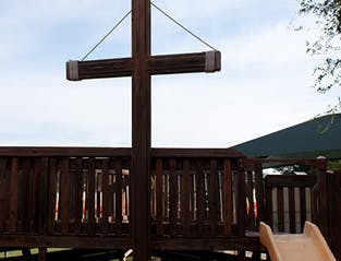 Wooden playground structure with a slide and slide