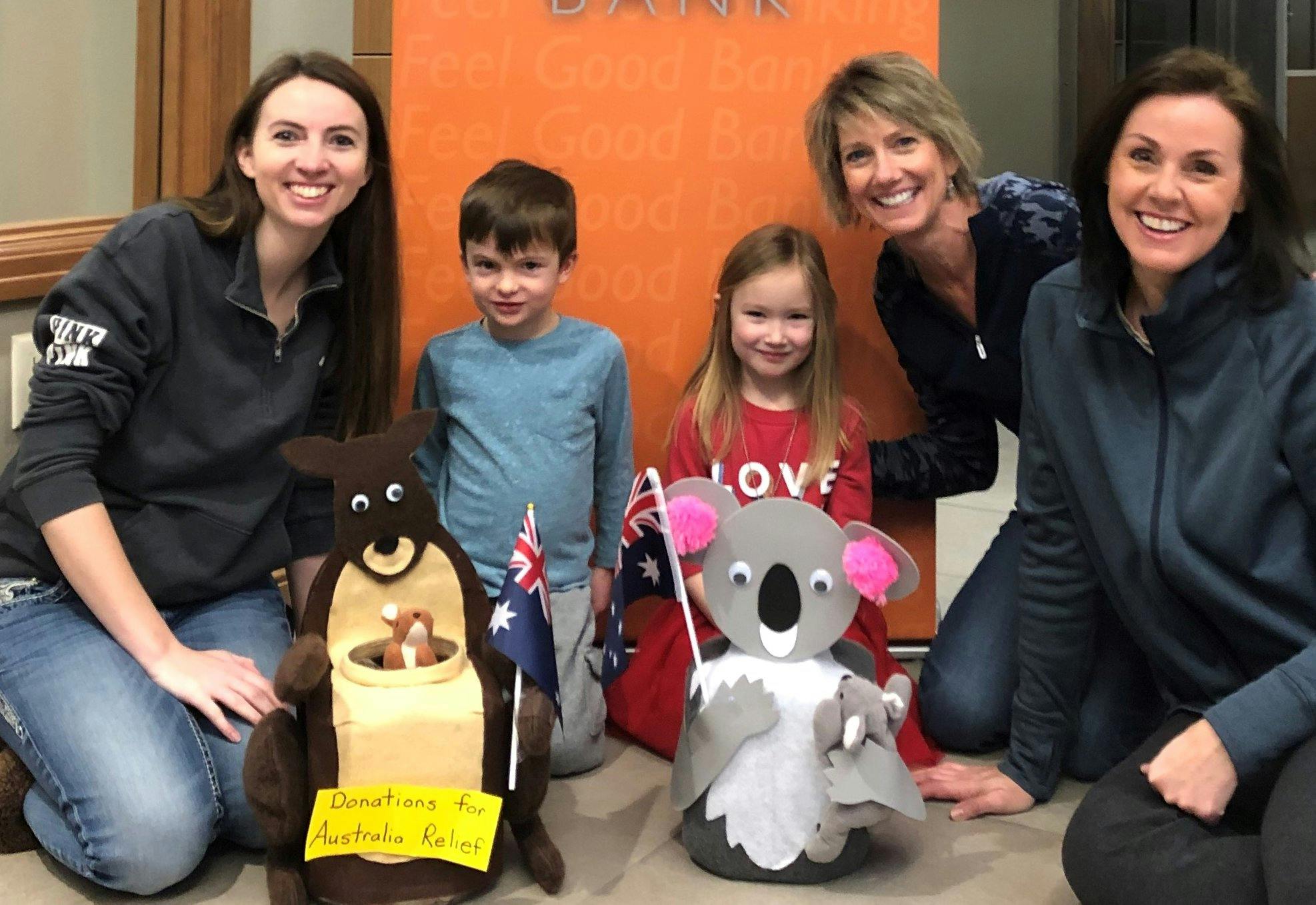 Two adults and two children with kangaroo and koala cutouts