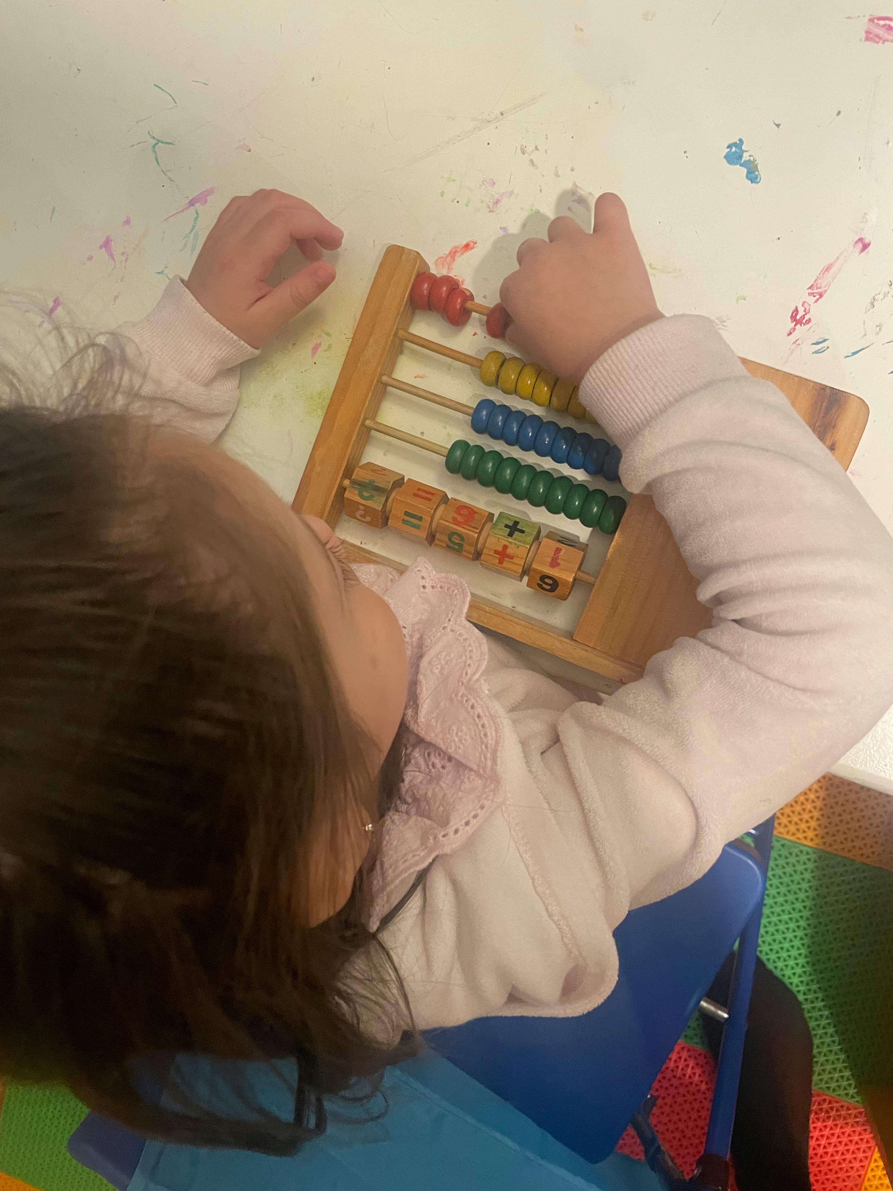 Child playing with an abacus