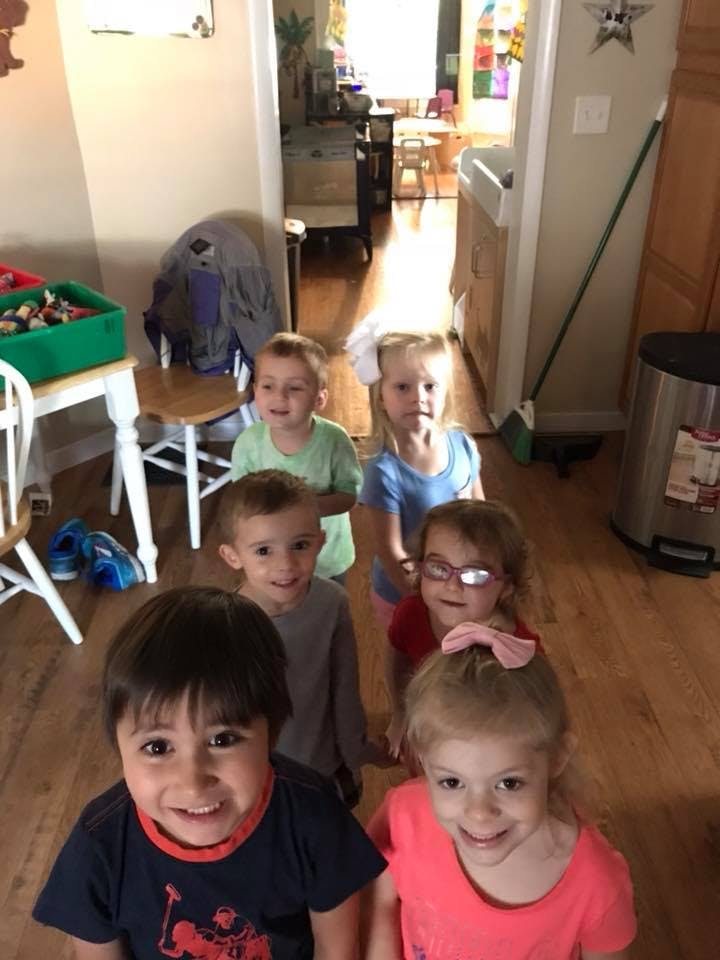 Group of children standing in a line indoors