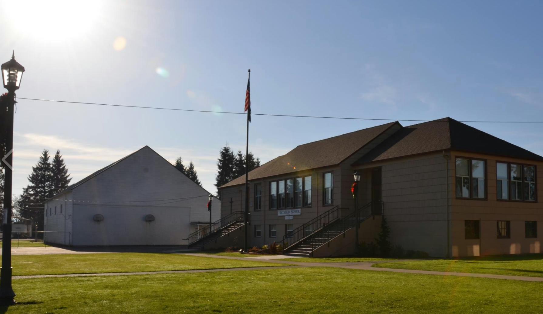Two buildings with a flagpole on a sunny day
