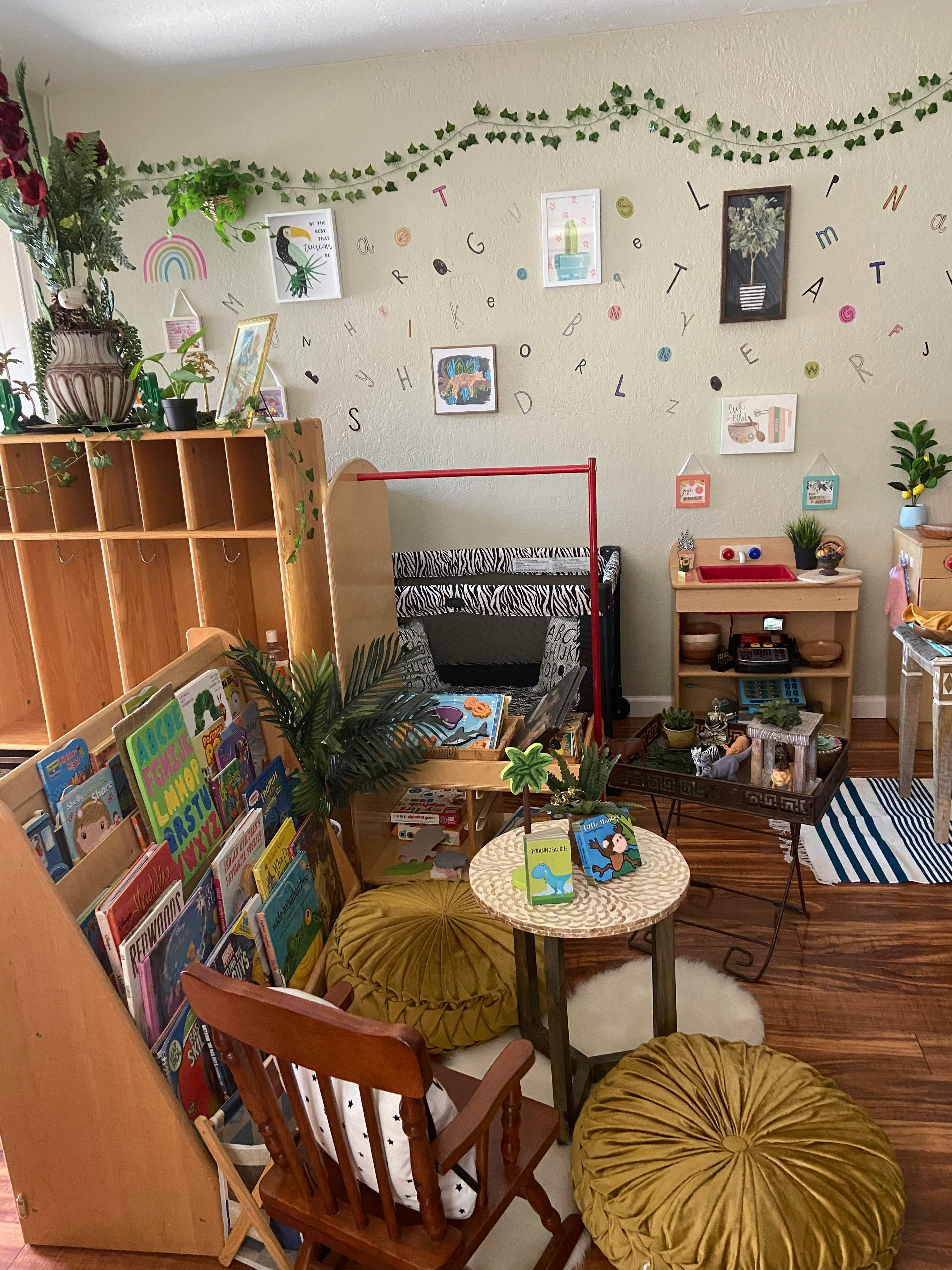Children's classroom with bookshelves, small tables, and wall decorations