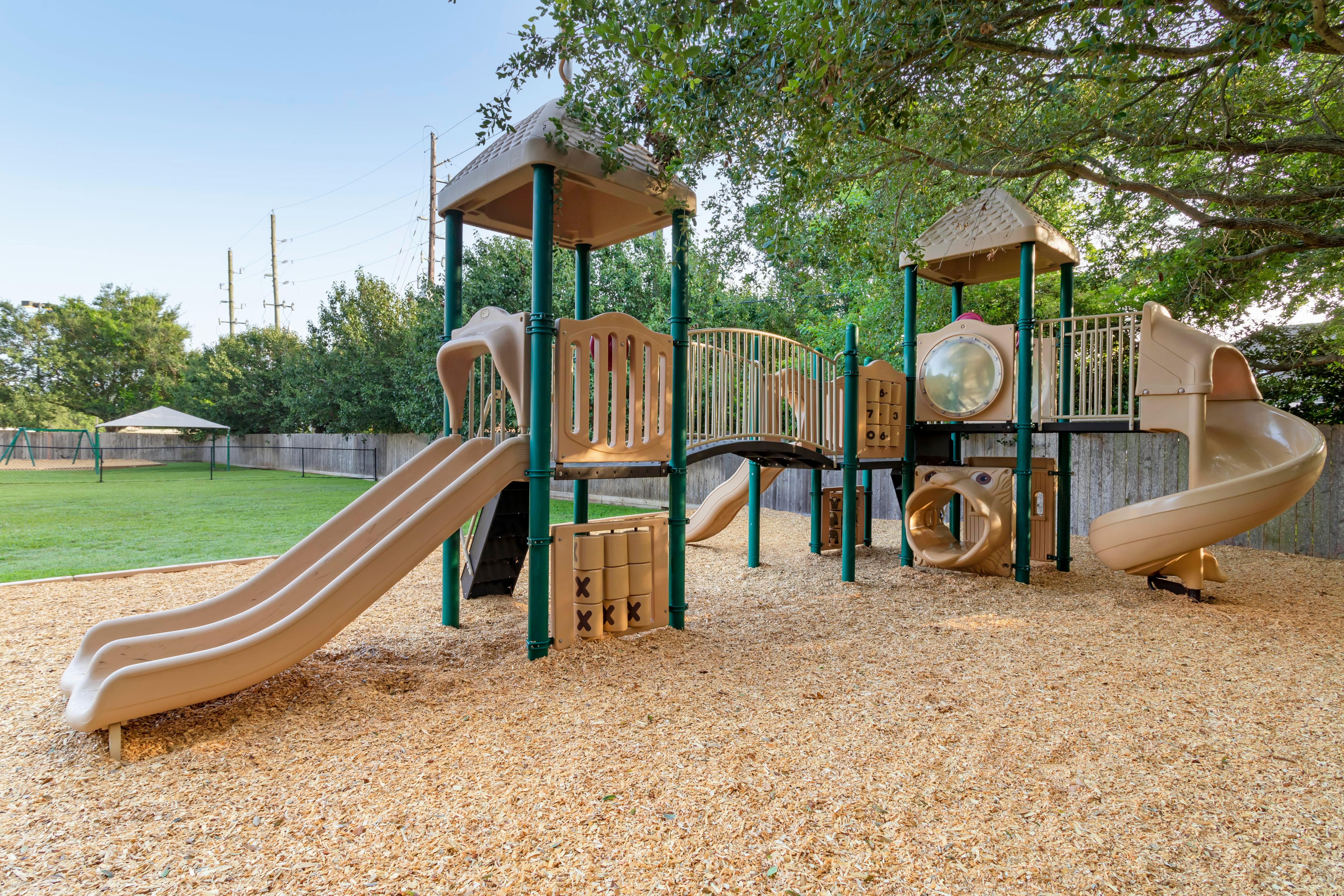 An empty playground with slides and climbing structures
