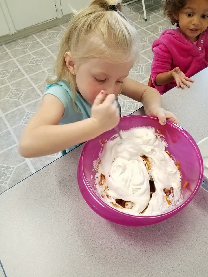 Child mixing ingredients in a bowl