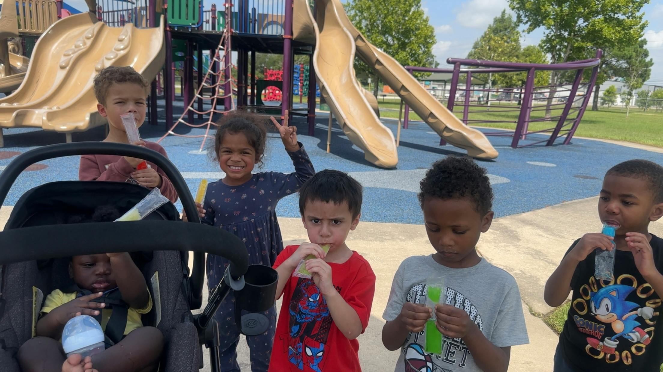 Children eating snacks at a playground