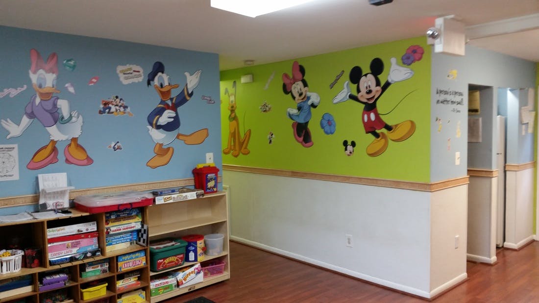 Room with cartoon character wall decals and shelves