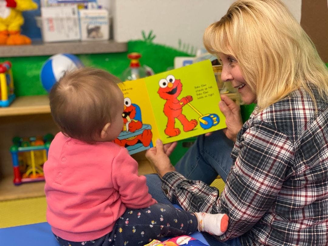 Person reading a book to a child