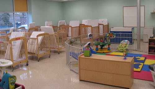 Room with multiple cribs and playpens