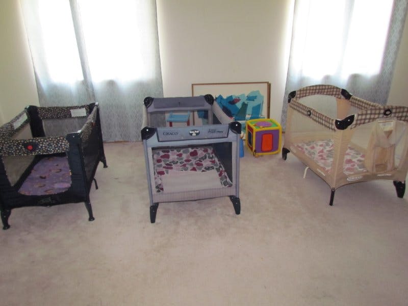 Three portable playards in a room