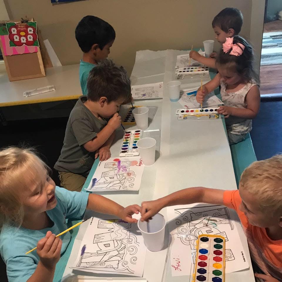 Children painting at a table