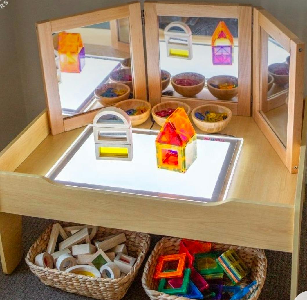 Light table with colorful translucent building blocks and mirrors