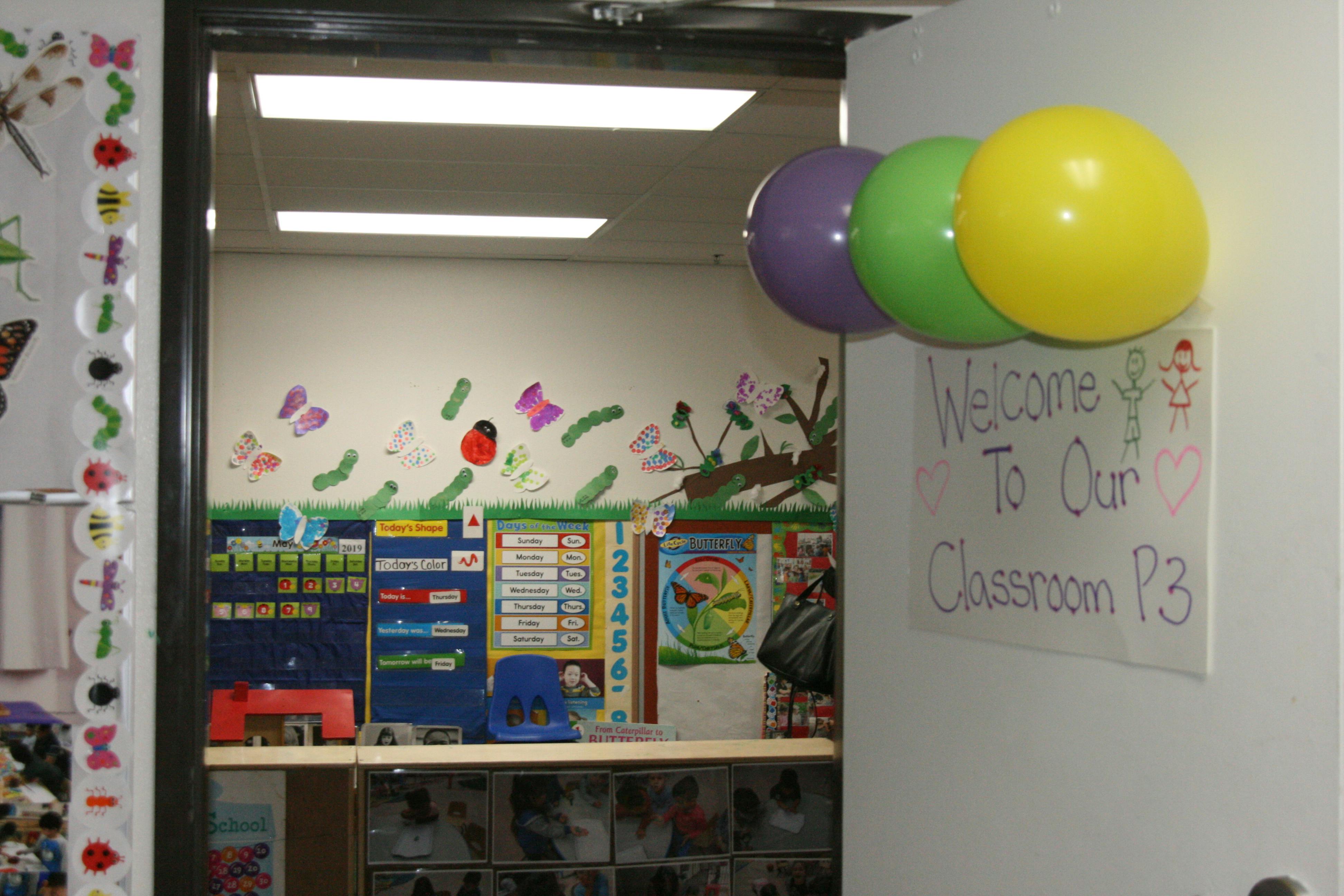 Classroom doorway with balloons and a "Welcome To Our Classroom" sign