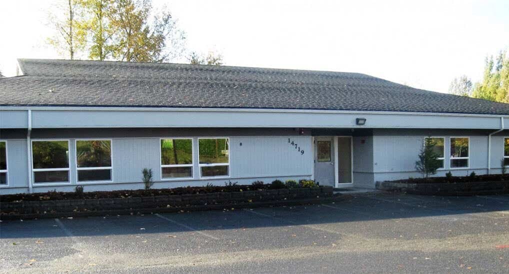 Single-story building with multiple windows and a dark roof