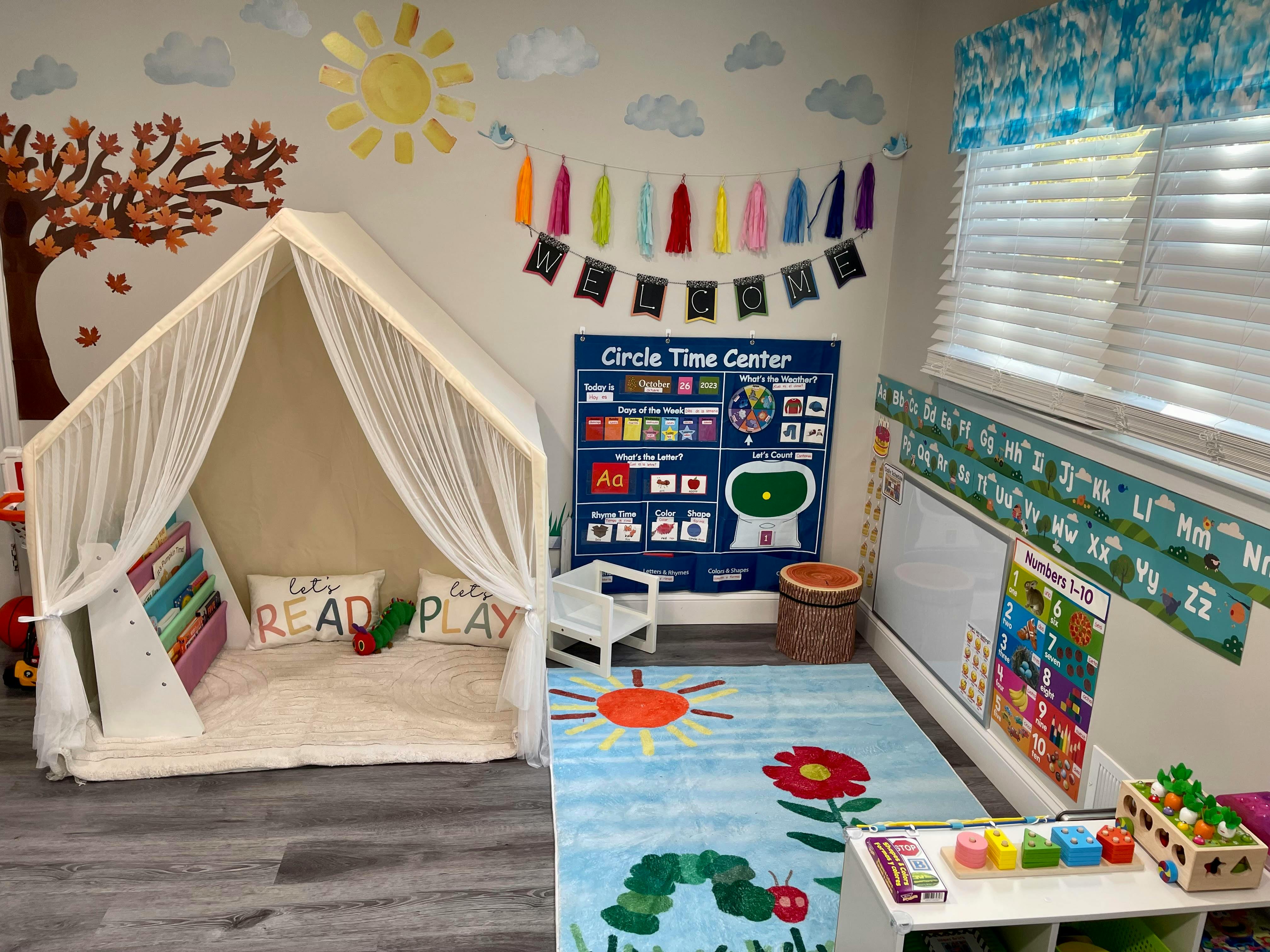 Children's play area with a tent, rug, and educational posters