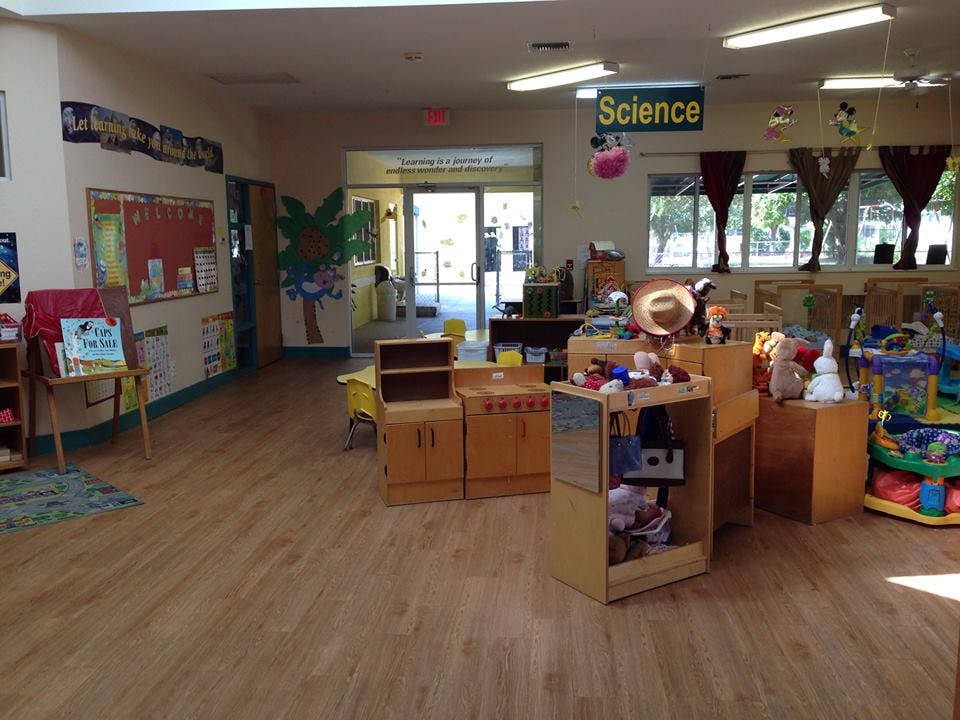 Classroom with wooden floor, bulletin board, and a "Science" sign