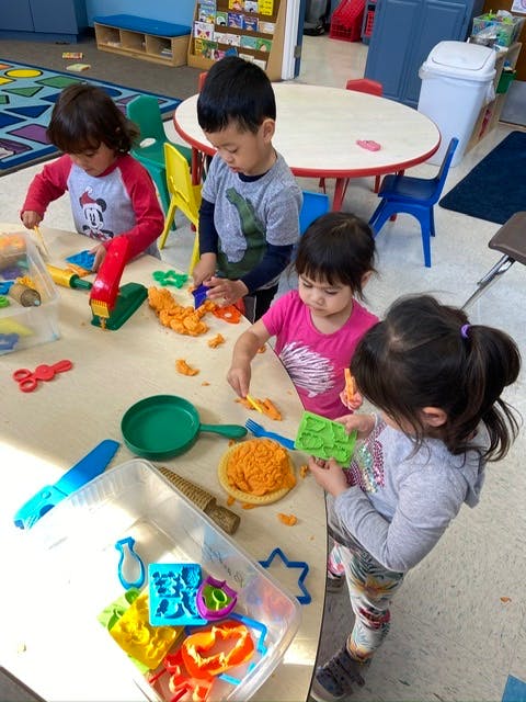 Children playing with modeling clay at a table