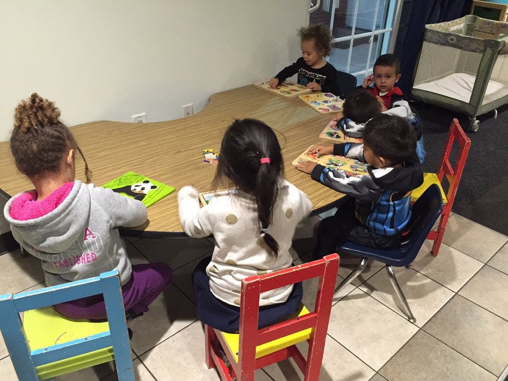 Children sitting at a table playing games