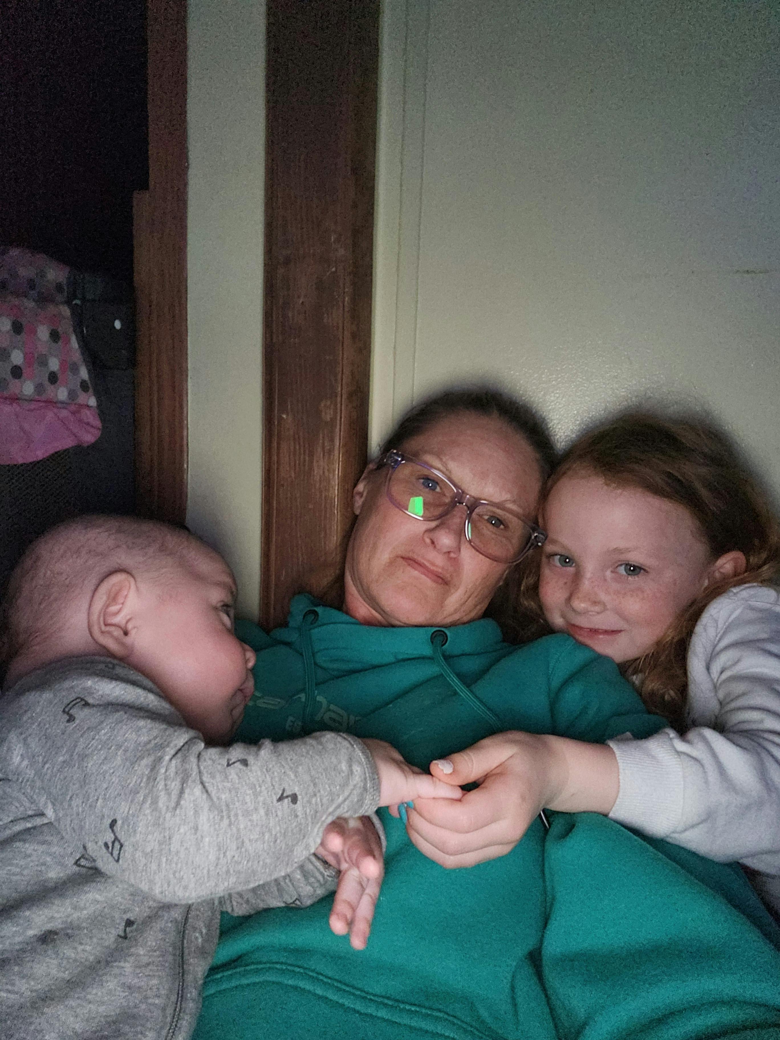 Person in glasses with a child and an infant