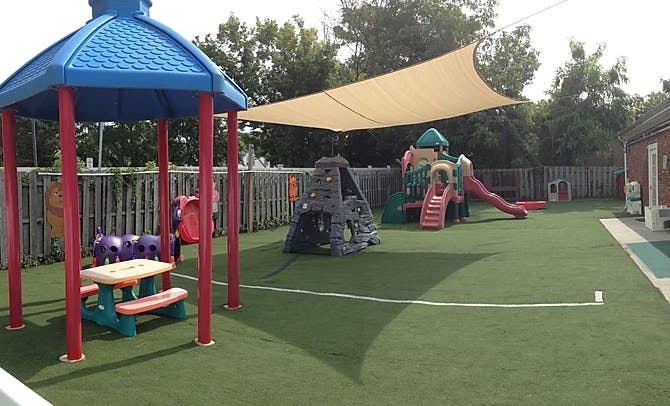 Outdoor playground with play structures and shade sails for children