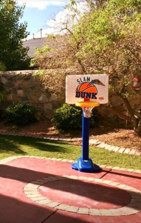 Toy basketball hoop with "Slam Dunk" text on the backboard