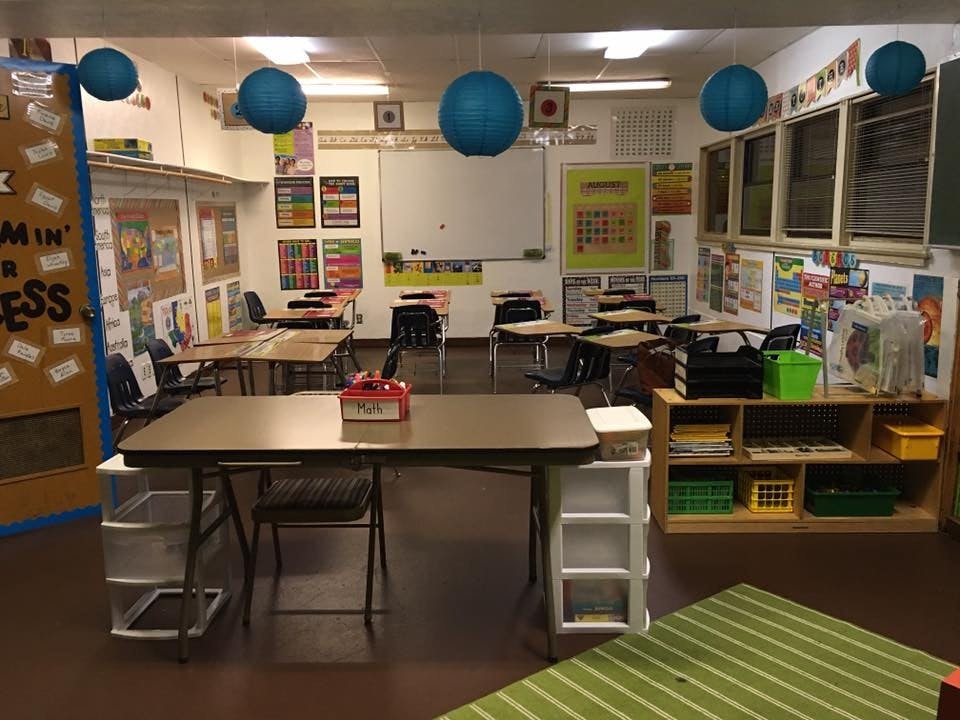 Empty classroom with desks, chairs, and decorations