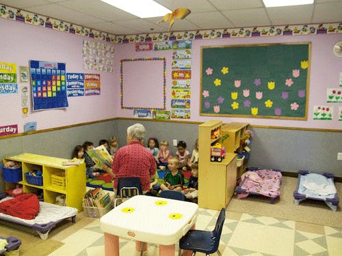 Adult reading to children in a classroom