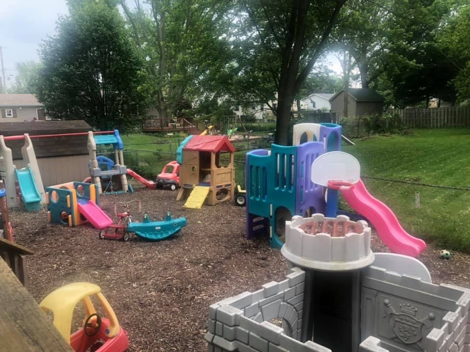 Outdoor playground with multiple slides, playhouses, and climbing structures