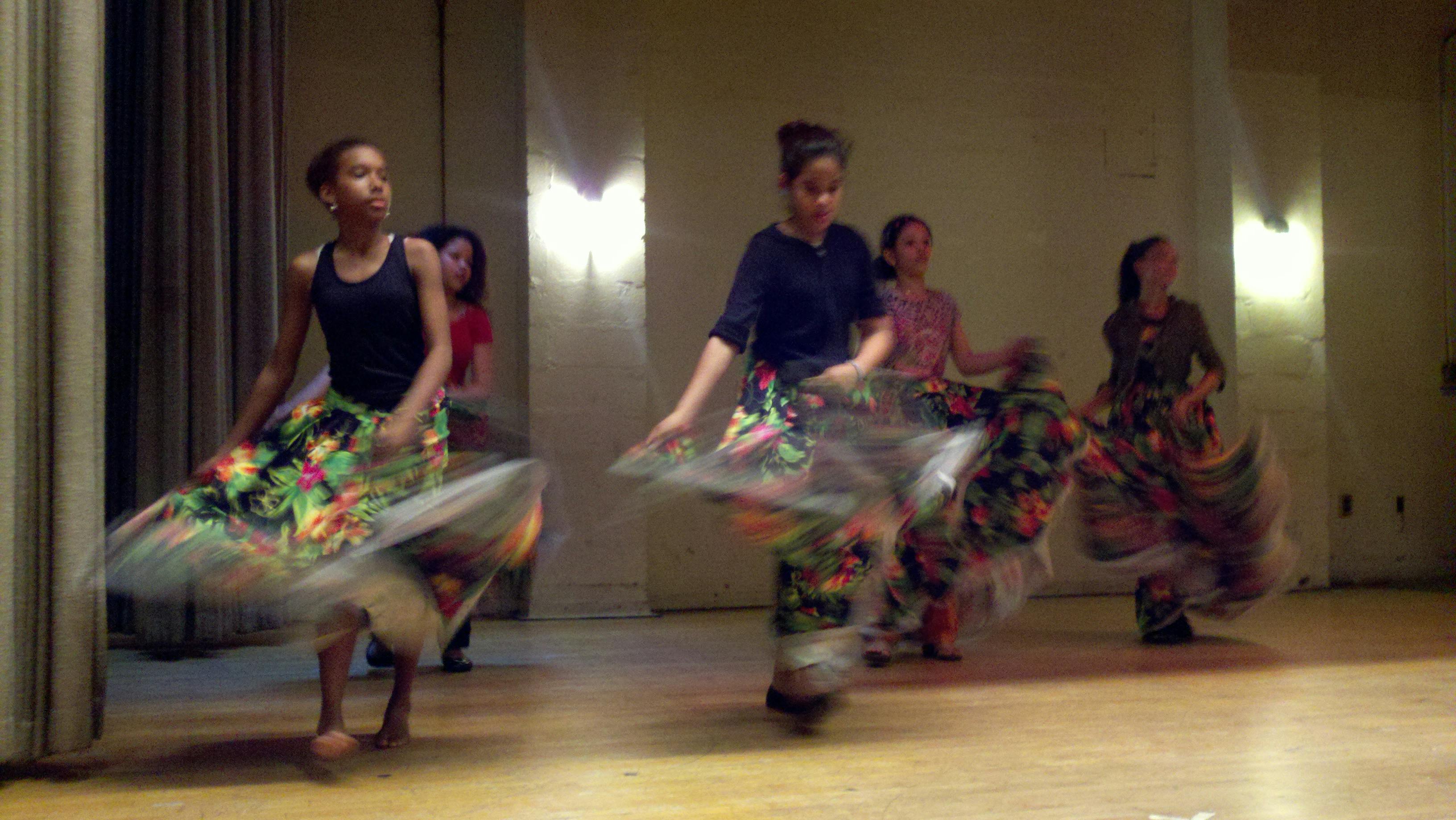People dancing in colorful skirts