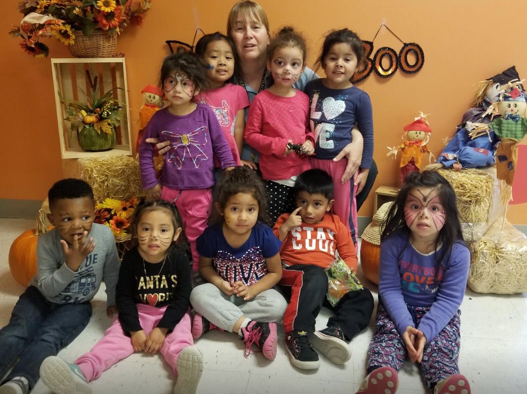 Adult and multiple children posing for a photo