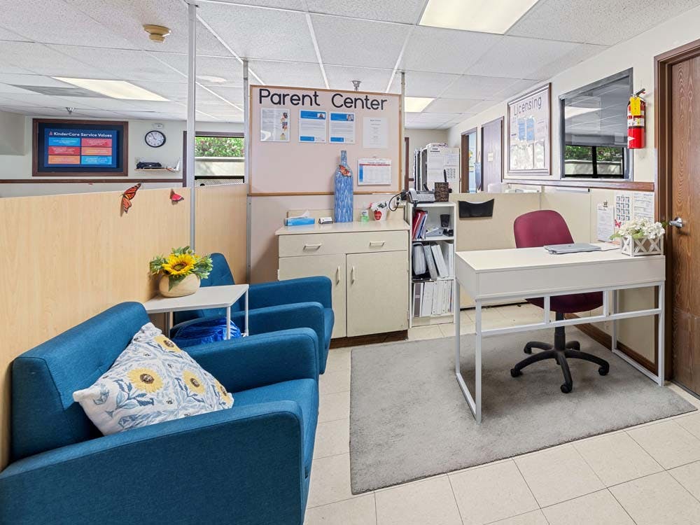 Lobby area with blue couches, a white desk, and a "Parent Center" sign