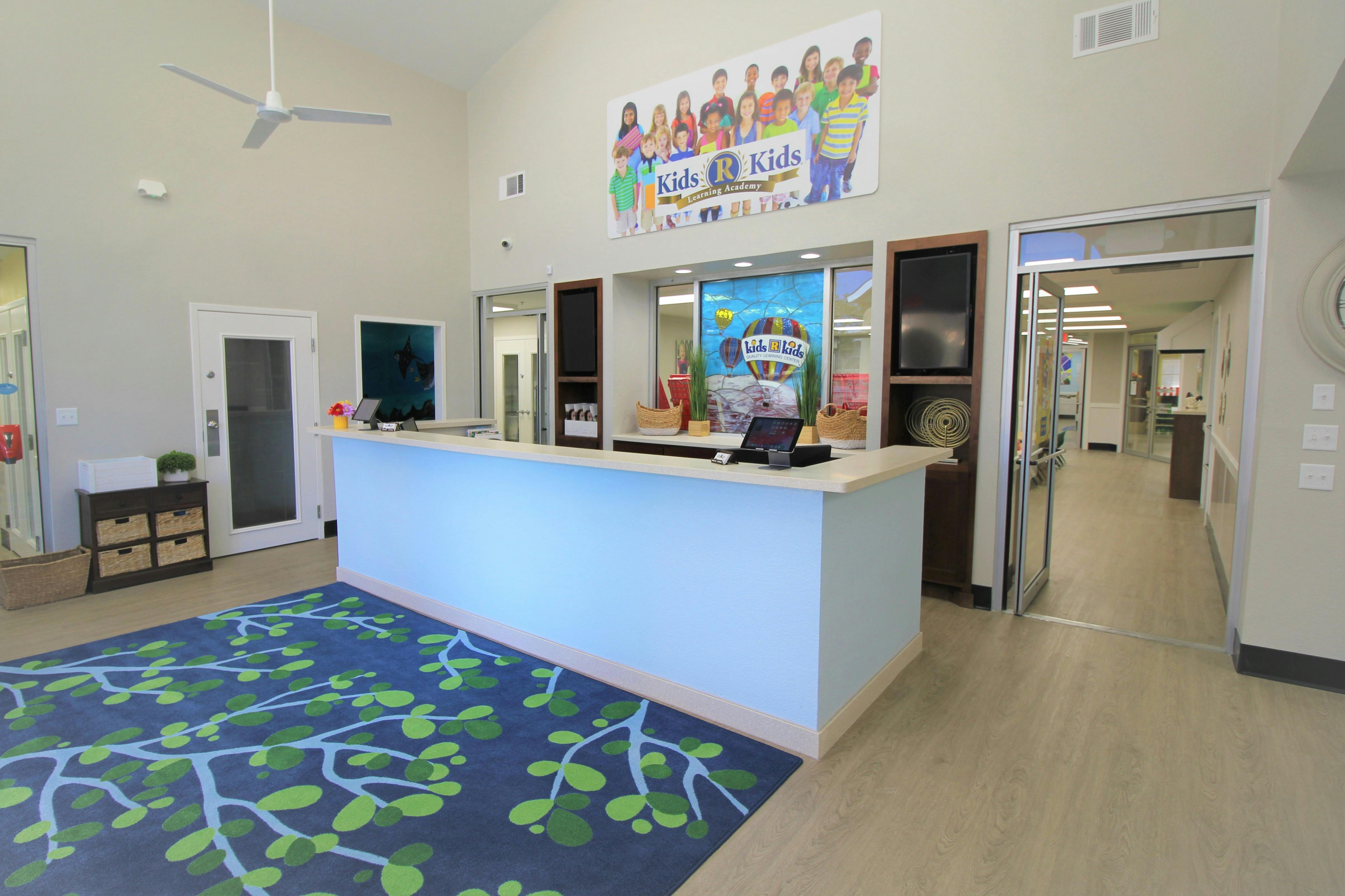 Reception area with a light blue counter and a colorful banner above
