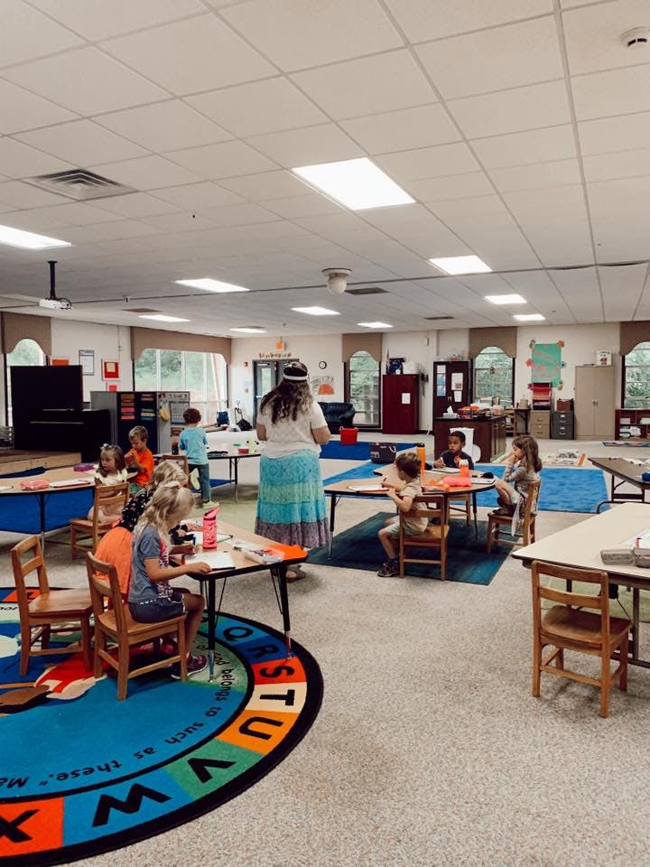 Adult and children in a classroom