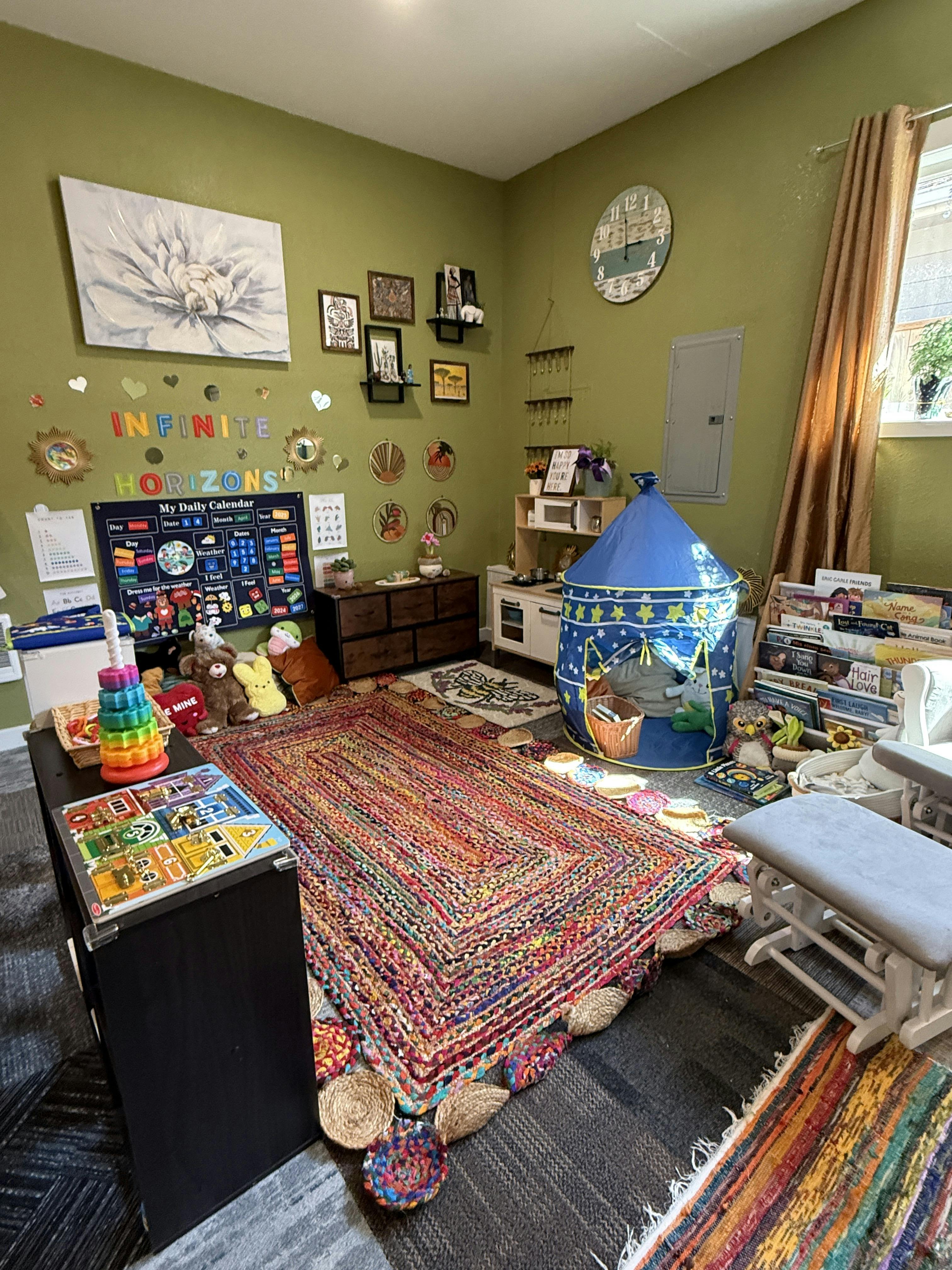 Playroom with a blue tent, colorful rug, and wall decorations