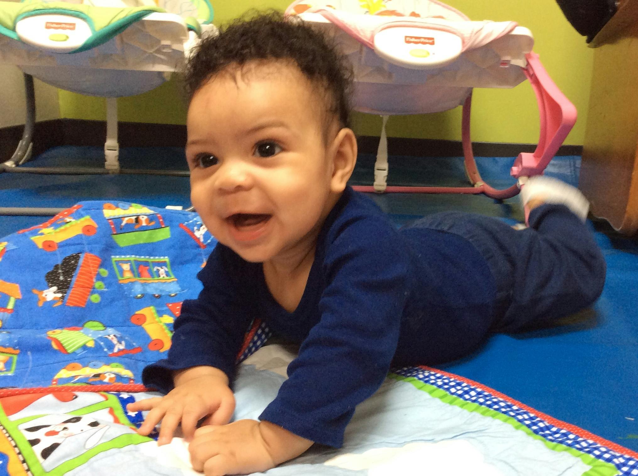Child crawling on a playmat