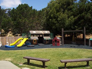 Playground with slides, playhouses, and swings
