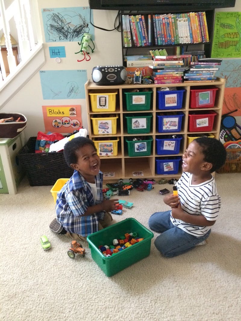 Two children playing with toys on the floor