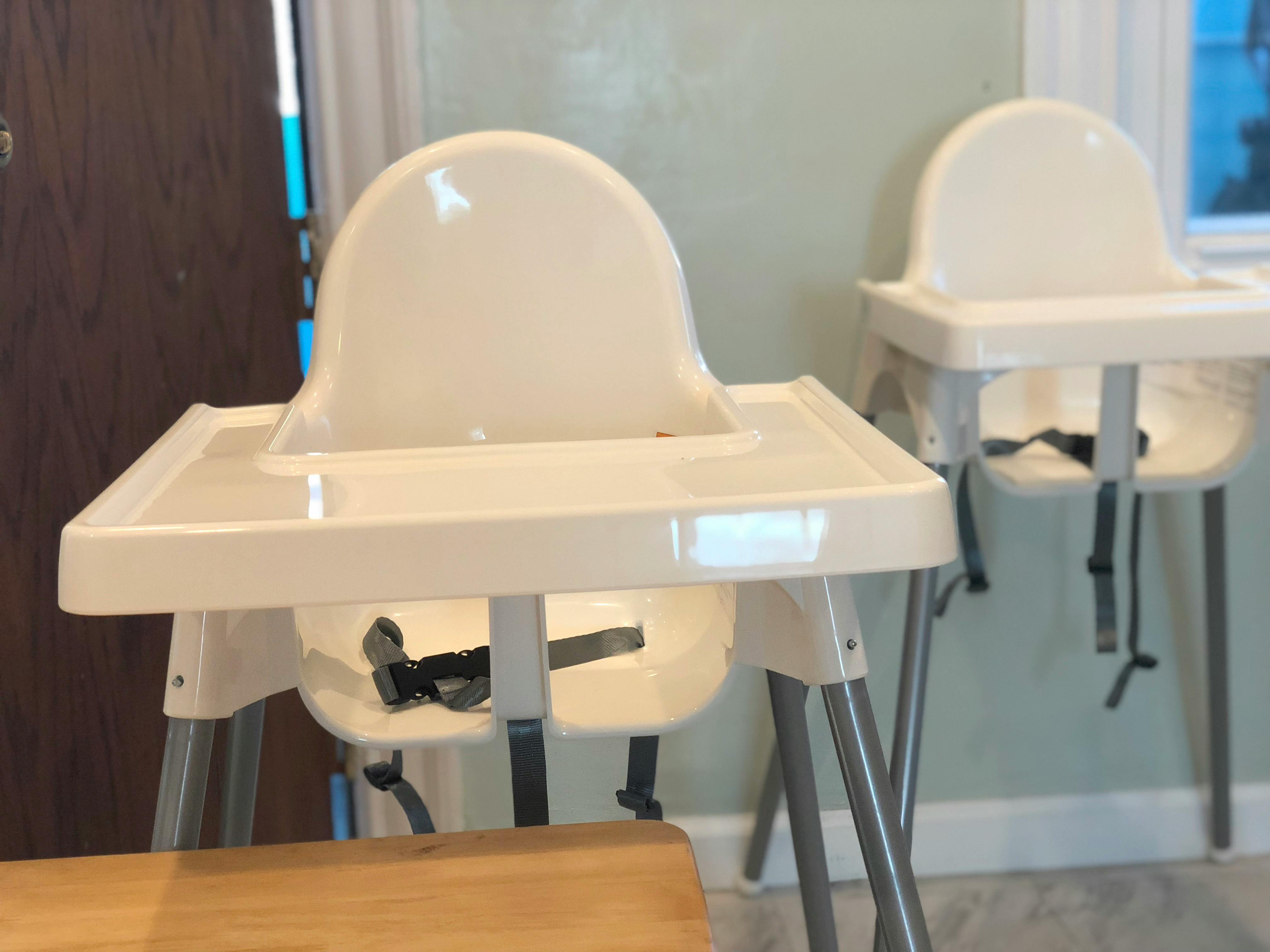 Two empty high chairs with trays