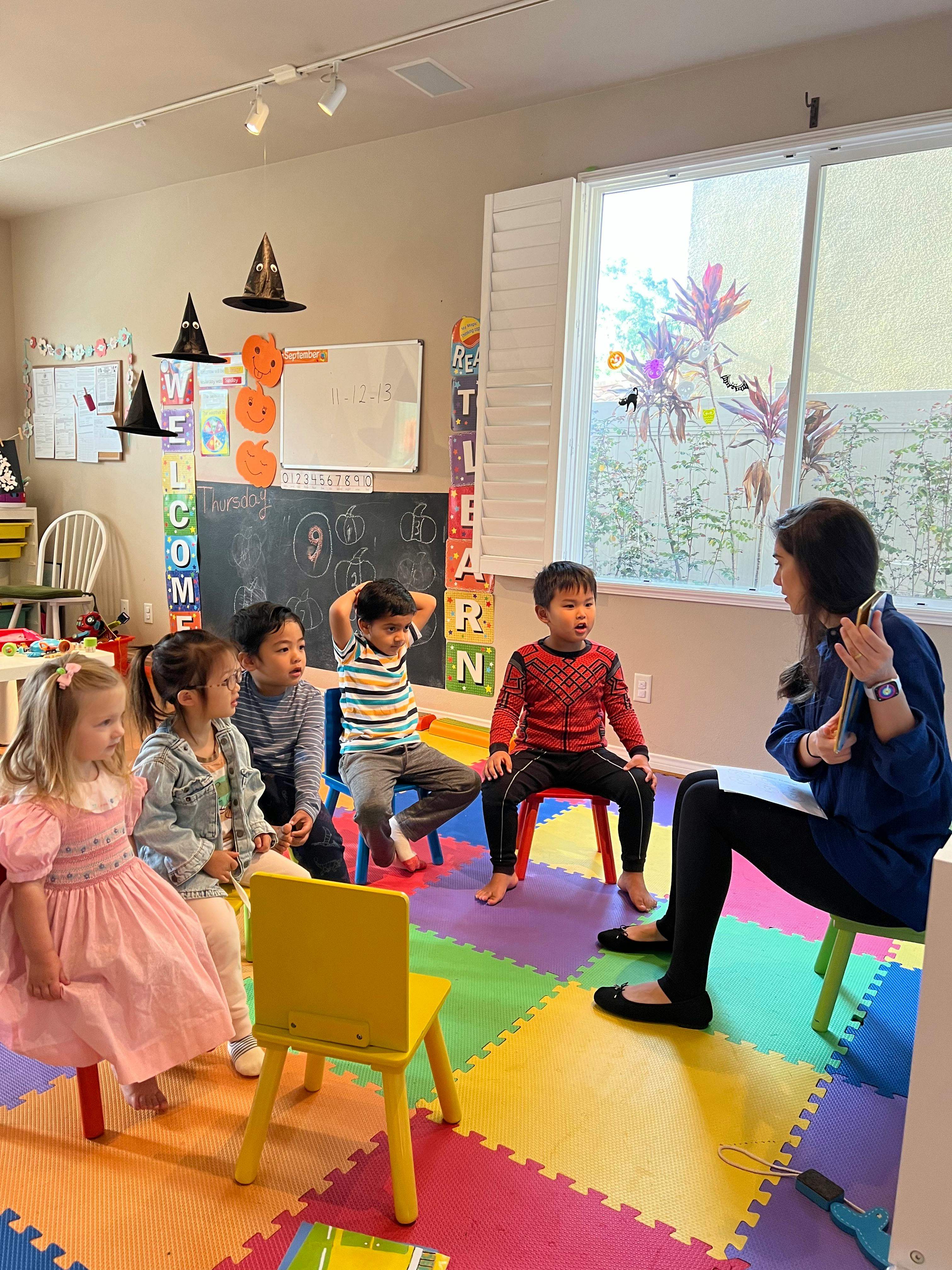 Adult reading to children in a classroom