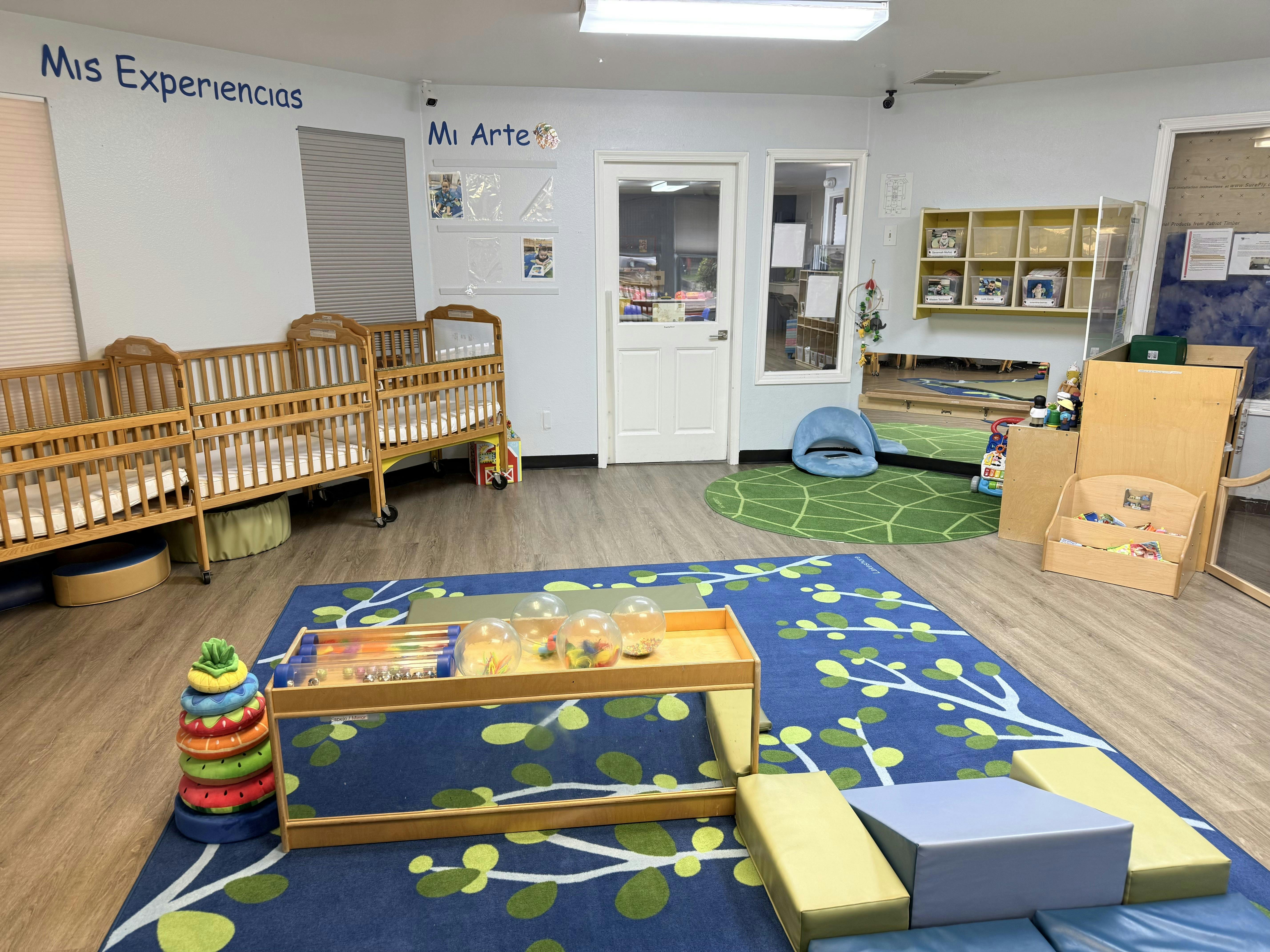 Cribs and toys inside a child care room