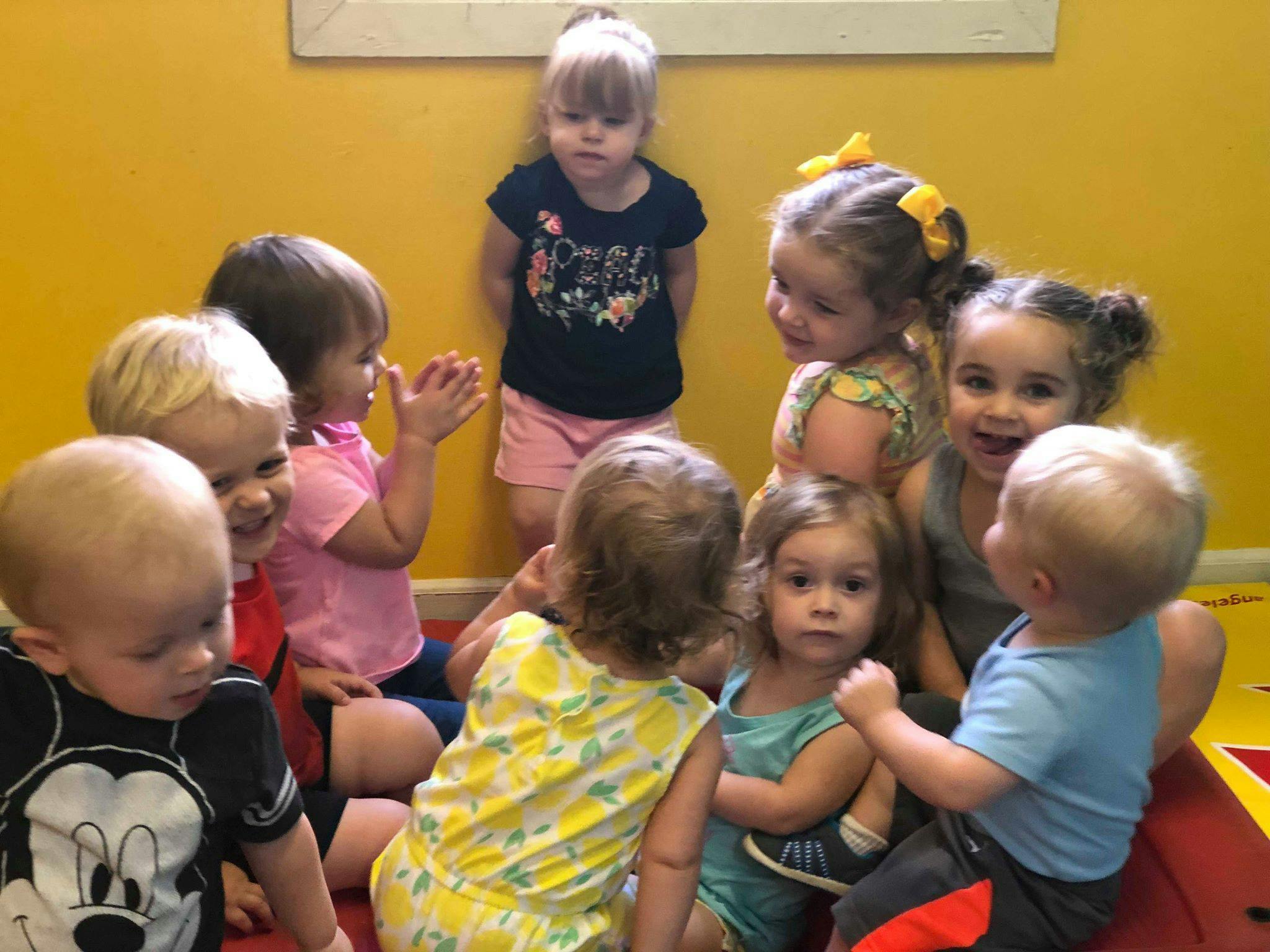 Group of children sitting and standing in a room