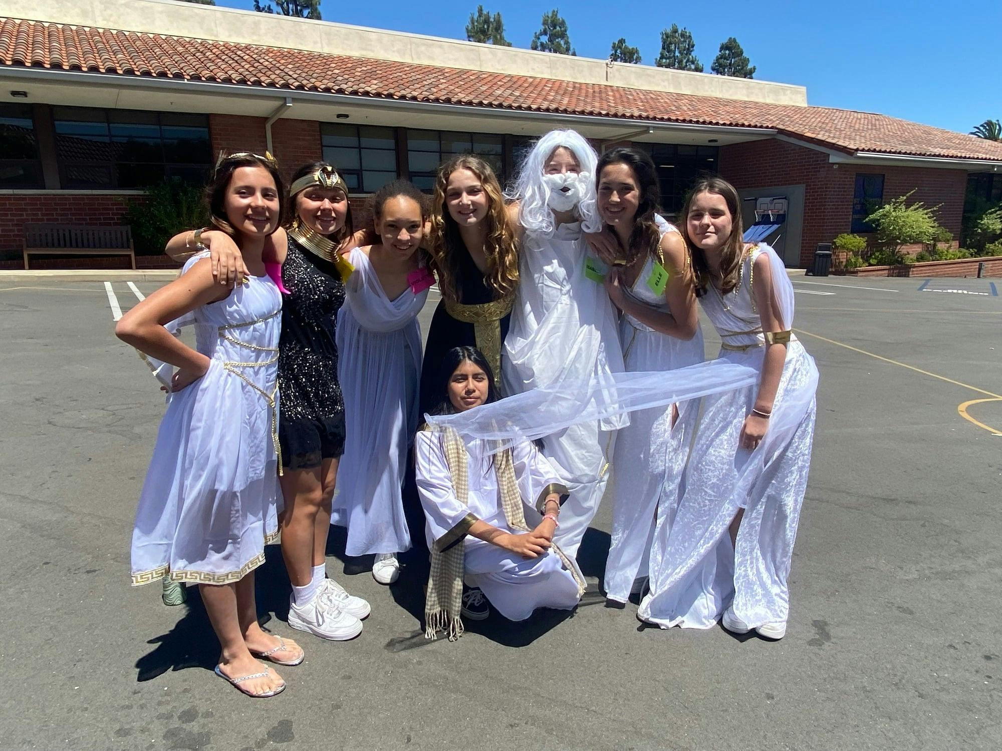 Group of teens in costumes standing on pavement