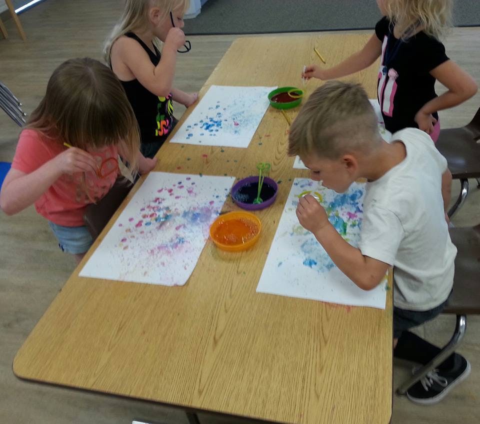 Children painting at a table