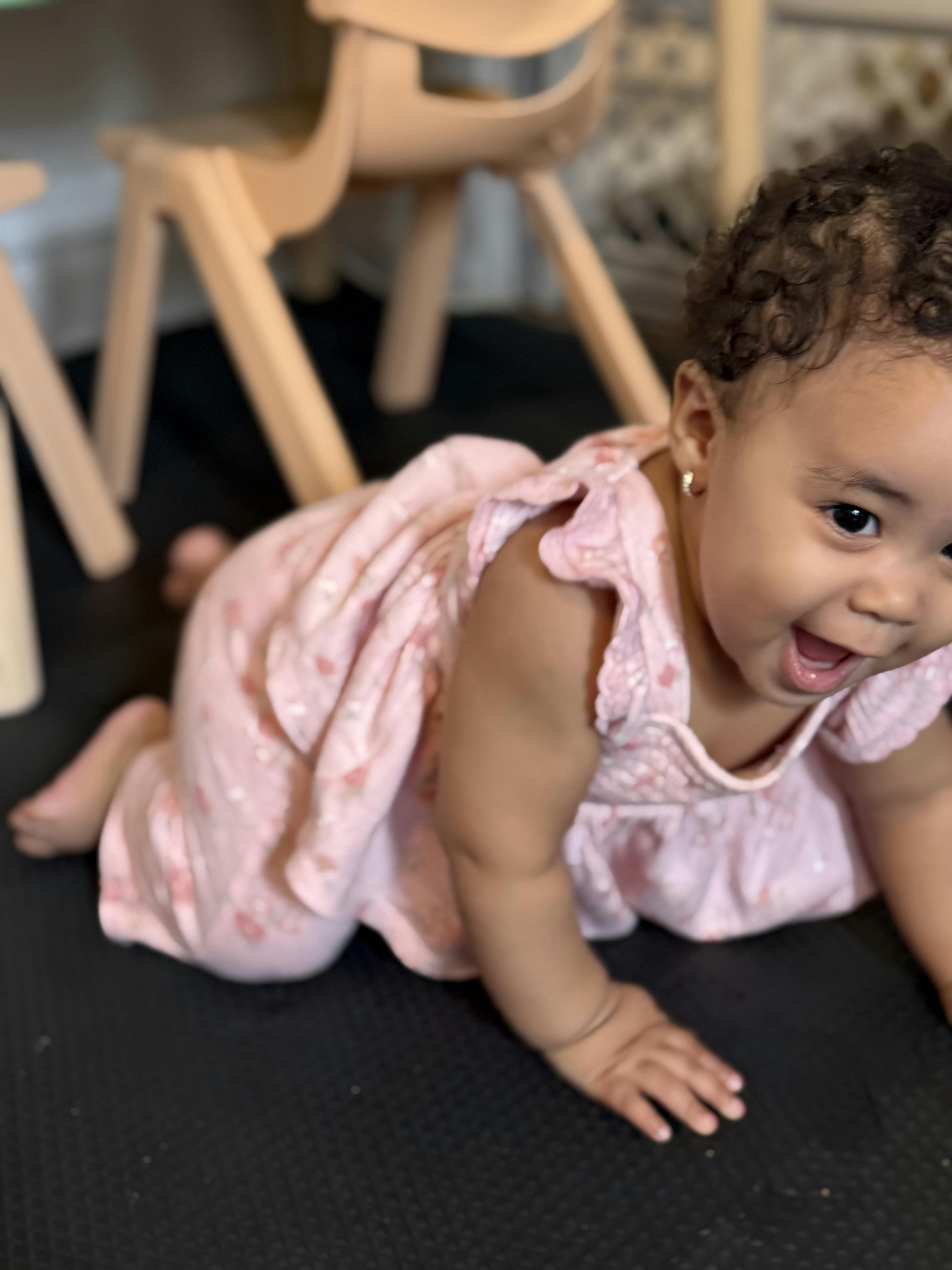 A young child crawling on a floor