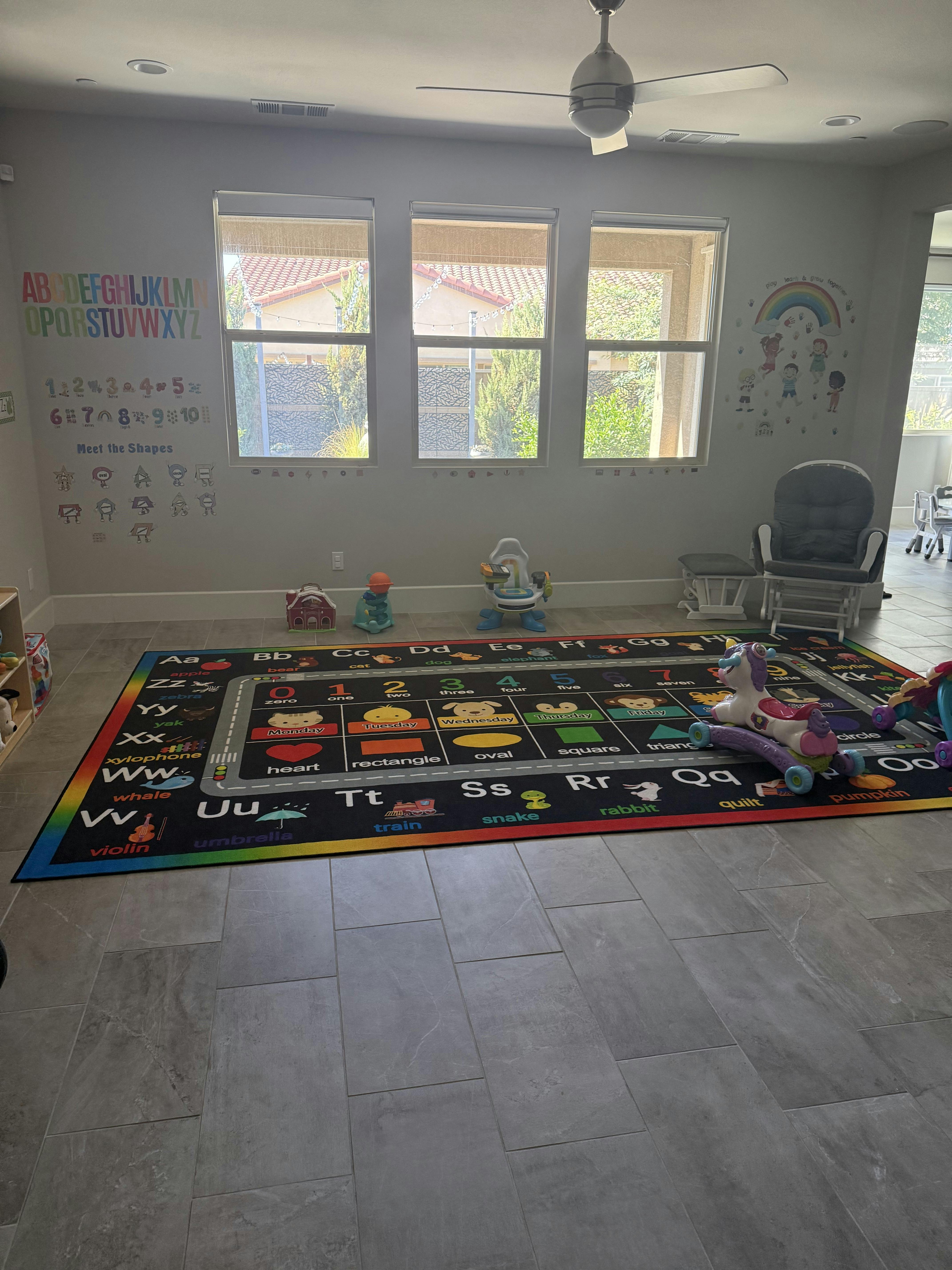 Playroom with alphabet rug and wall decals
